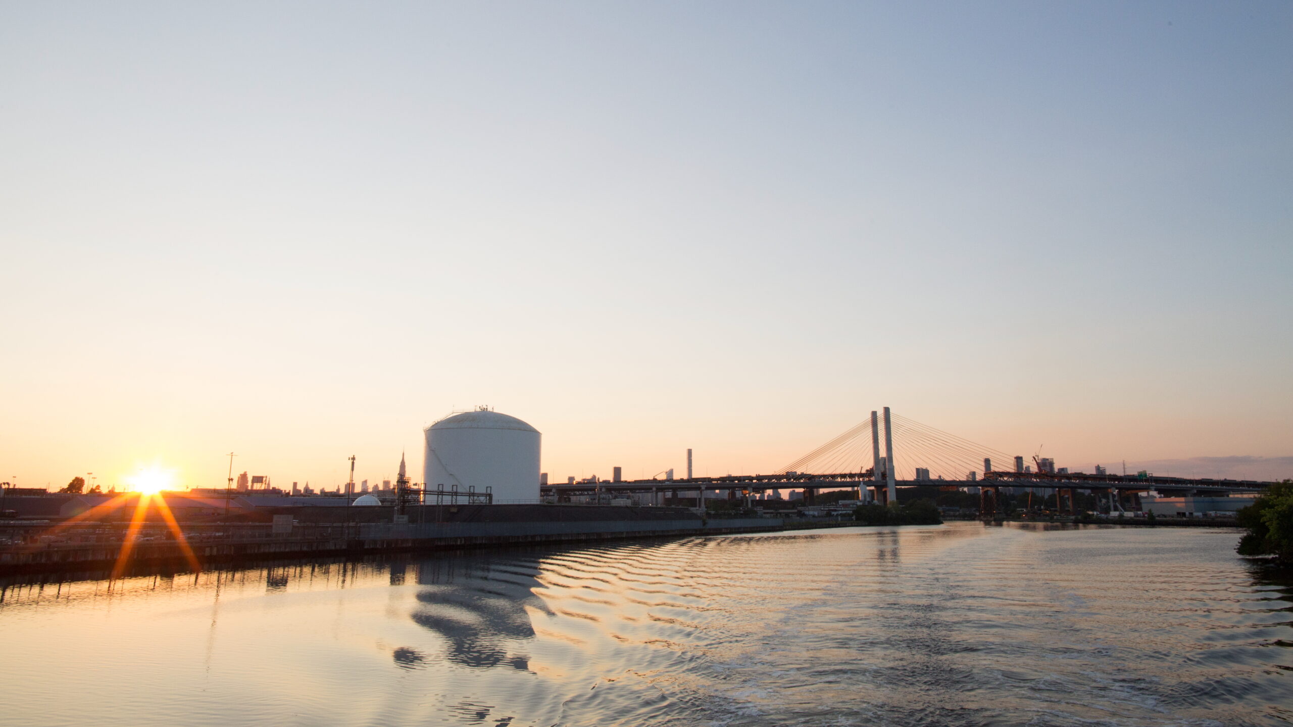 A view of the sunset over Newtown Creek, separating North Brooklyn and Long Island City, Queens. The Kosciuszko Bridge is visible in the background.