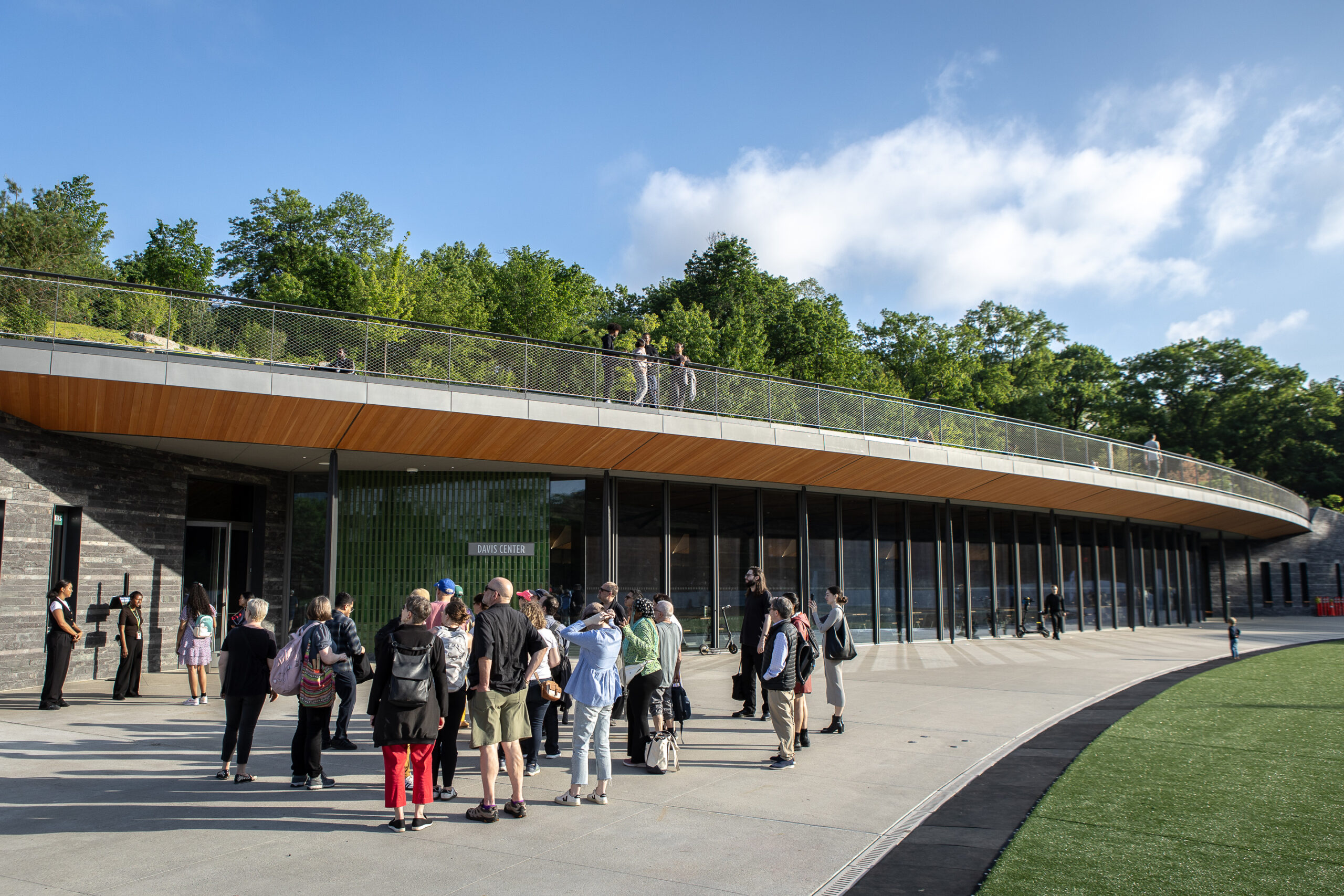 A tour group stands in front of the ground-level entrance to the Davis Center in Central Park.