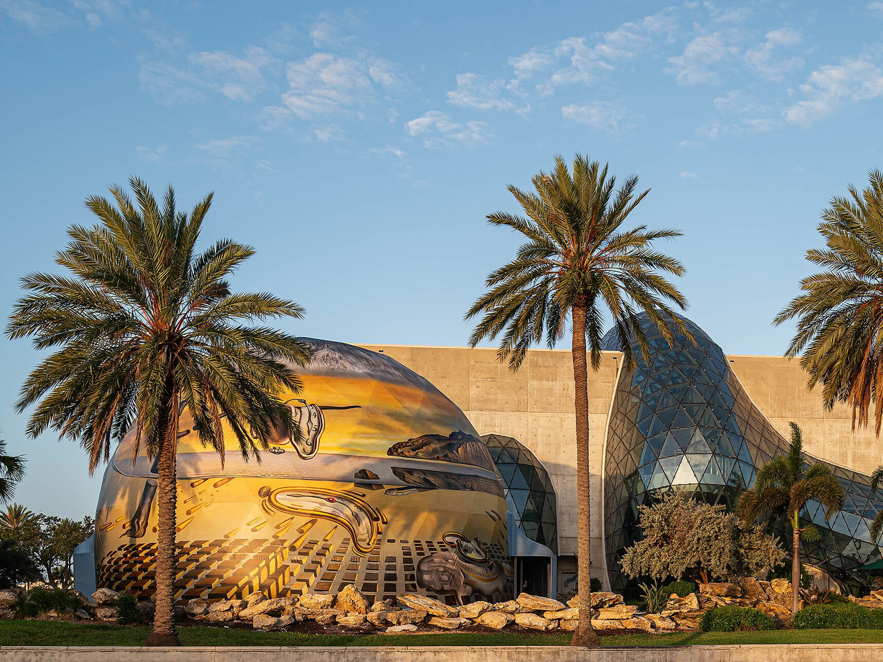 A building with palm trees in front