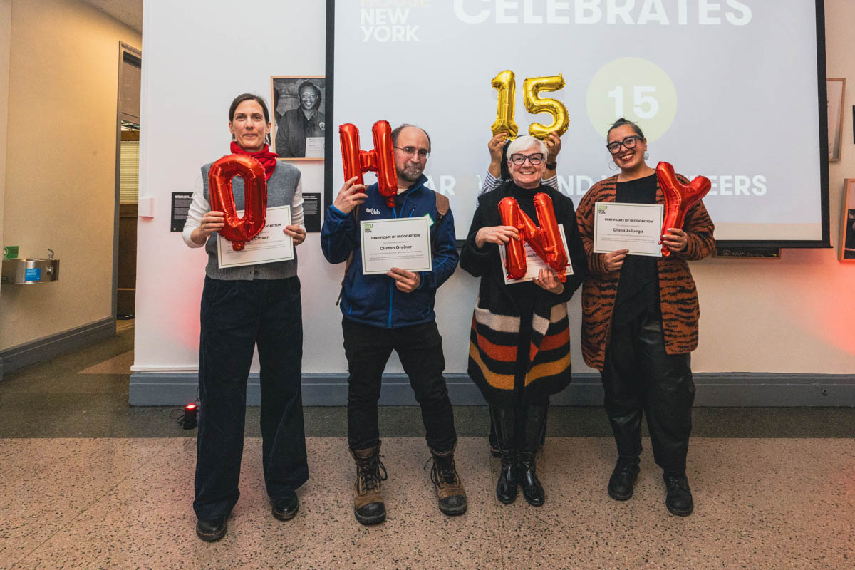 A group of four people holding balloons that spell out "OHNY 15"